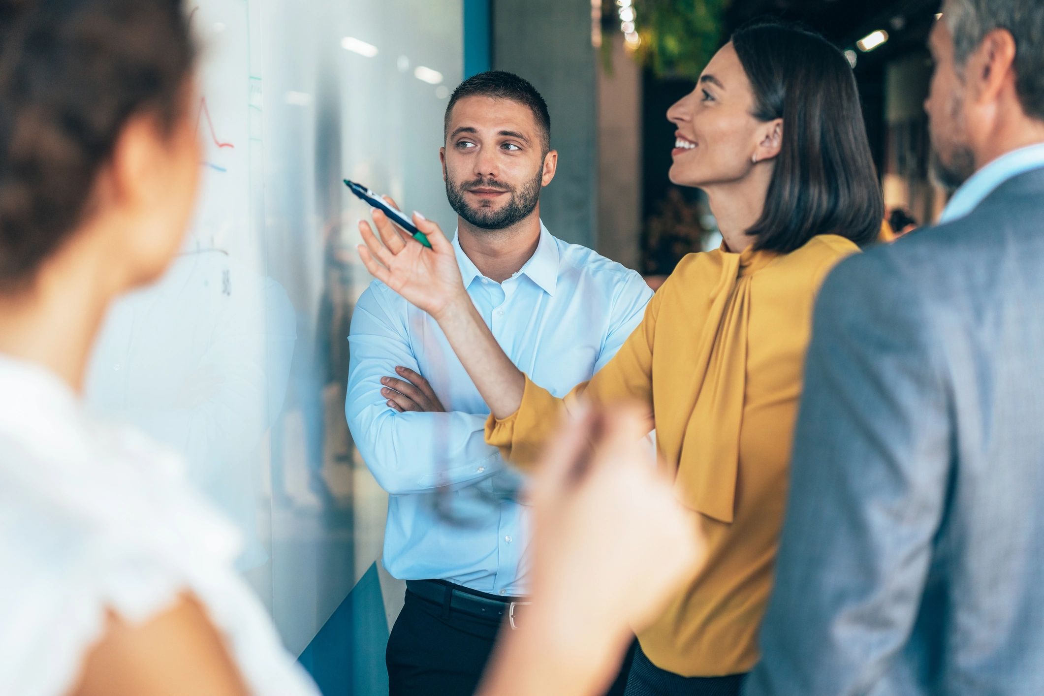 Business team collaborating around a whiteboard