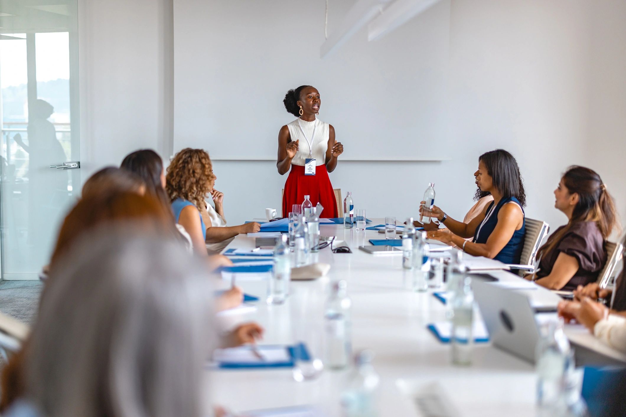 Woman Giving Presentation At Conference Table During Women Only Business Meeting