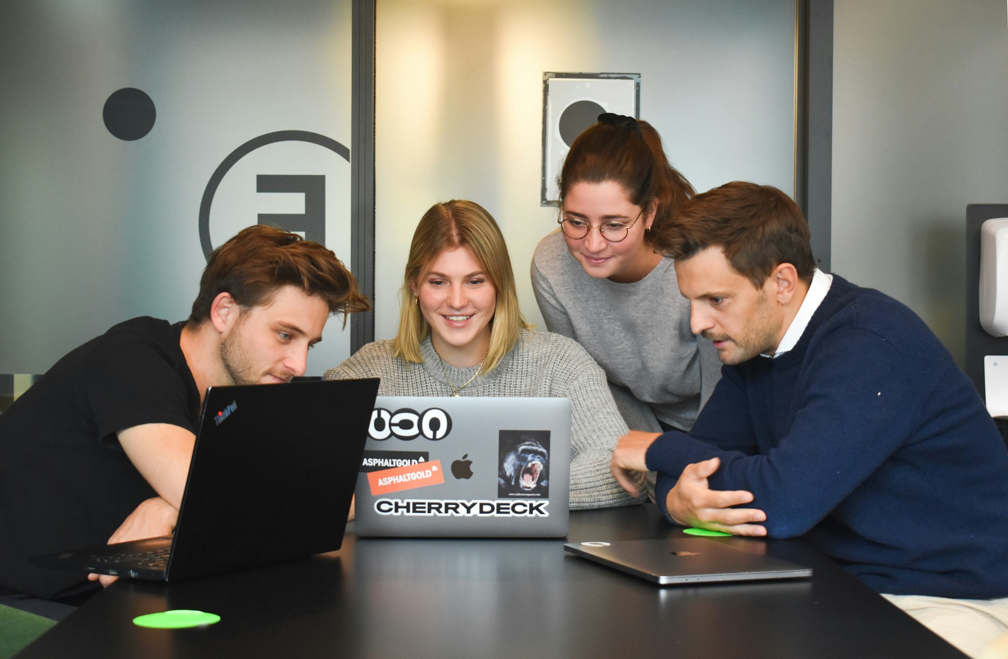 Small team working together around a laptop